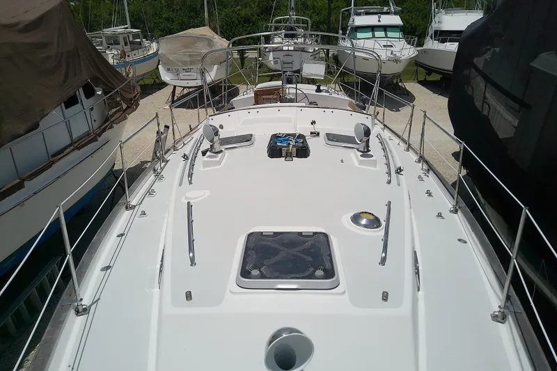 Slide: The Image of 1988 Brewer 44 sailboat deck view in a marina with surrounding boats. - 19