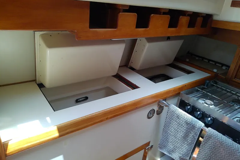 Slide: The Image of Interior of a 1988 Brewer 44 yacht kitchen with stove and storage compartments. - 47