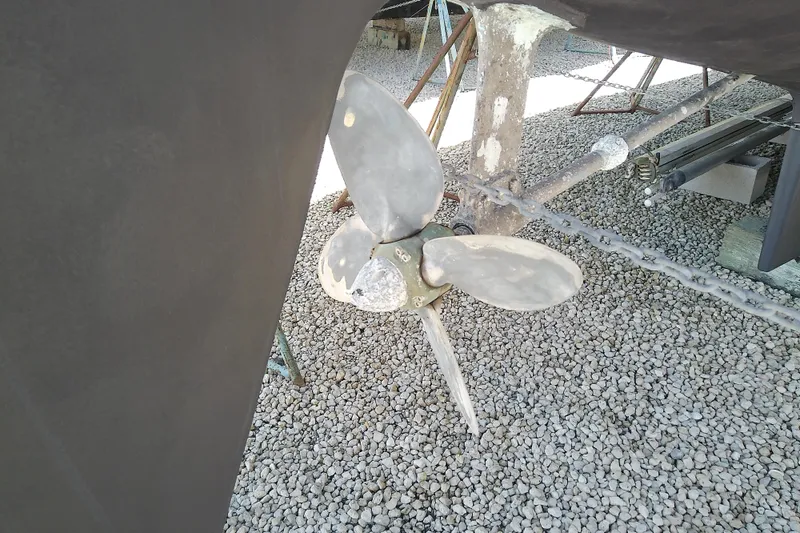 Slide: The Image of Propeller of a 1988 Brewer 44 sailboat on gravel surface. - 11