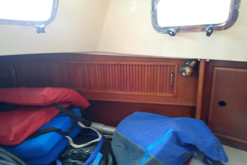 Slide: The Image of Interior of 1988 Brewer 44 sailboat with life jackets and wooden cabinetry. - 81