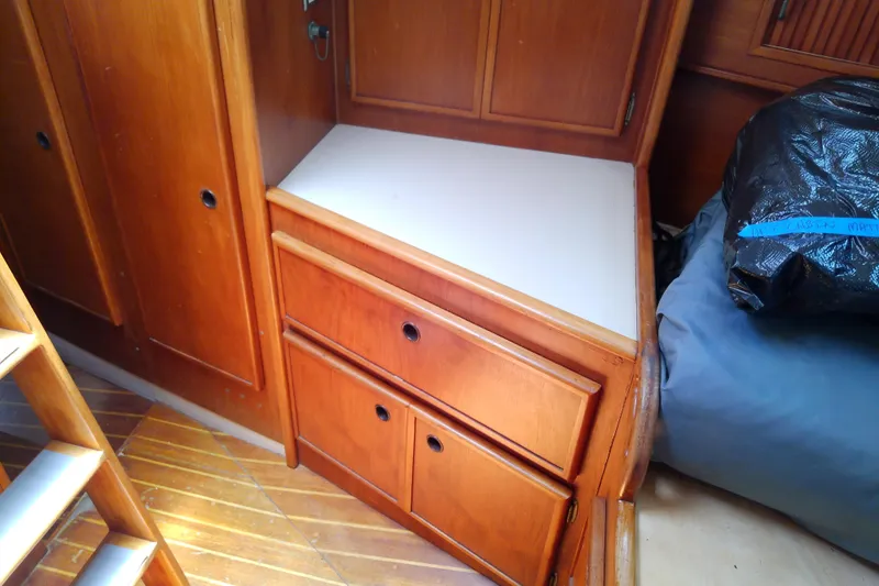 Slide: The Image of Wooden cabin interior with drawers in a 1988 Brewer 44 boat. - 82