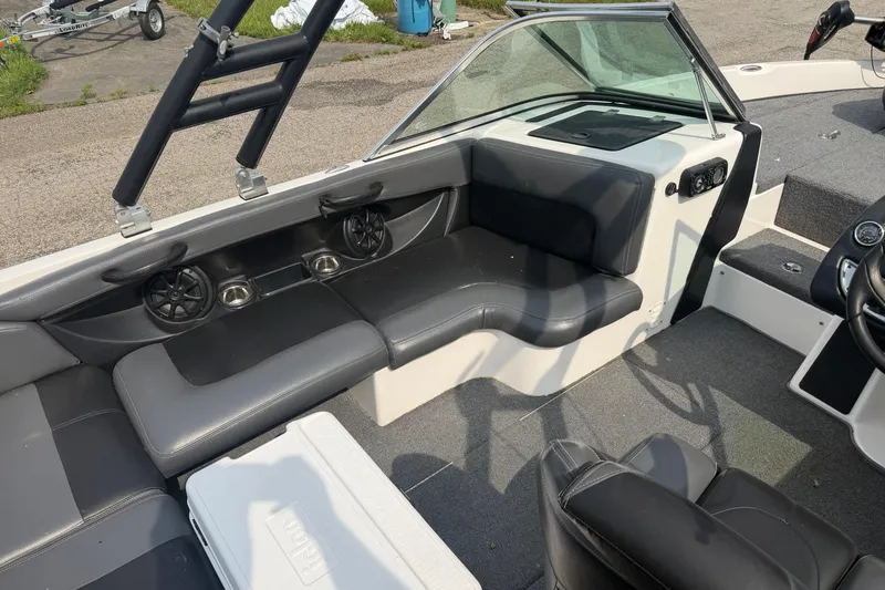Slide: The Image of Interior of a 2013 Triton 220 Escape boat with seating and speakers. - 2