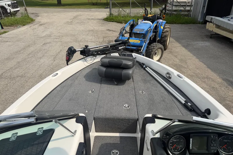 Slide: The Image of 2013 Triton 220 Escape boat with trolling motor and tractor in background. - 4