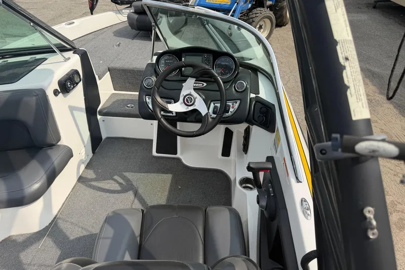Slide: The Image of Interior view of 2013 Triton 220 Escape boat, featuring steering wheel and dashboard controls. - 1