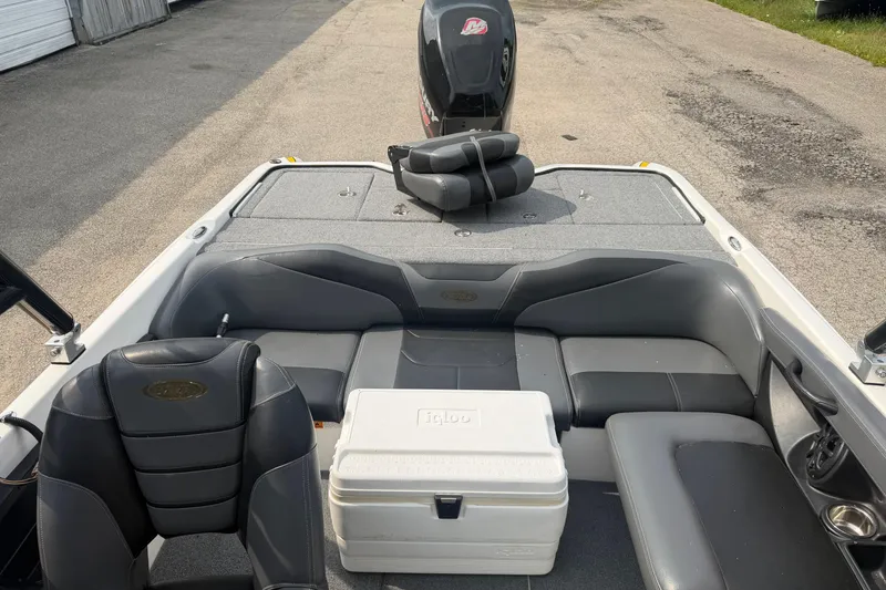 Slide: The Image of Interior of a 2013 Triton 220 Escape boat with seating and cooler. - 3