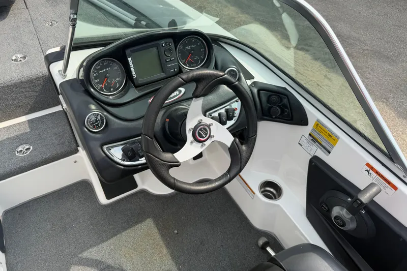 Slide: The Image of Steering console of a 2013 Triton 220 Escape boat with gauges and controls. - 5