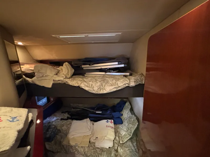 Slide: The Image of A cozy cabin with bunk beds and stacked linens, surrounded by wooden walls. - 21