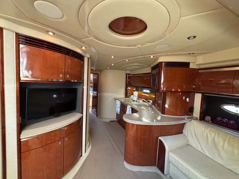Slide: The Image of Interior of a 2003 Sea Ray 500 Sundancer with elegant wood furnishings and a modern kitchen. - 19