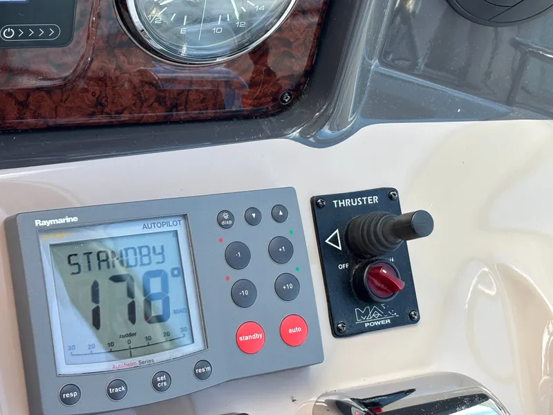 Slide: The Image of Close-up of a boat control panel with autopilot and thruster controls. - 11