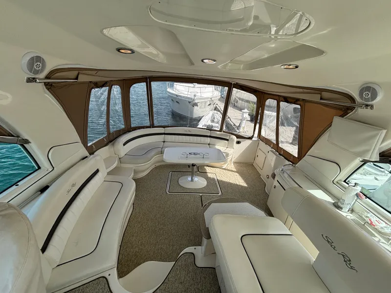 Slide: The Image of The image shows the spacious cockpit of a 2003 Sea Ray 500 Sundancer with elegant seating. - 5