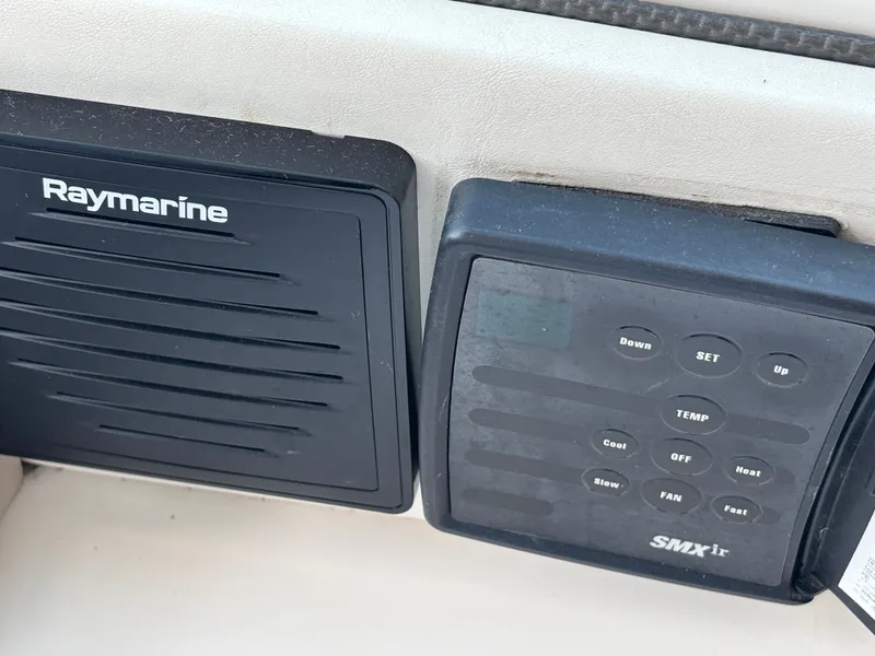 Slide: The Image of Close-up of two electronic control panels on a boat, including a Raymarine device. - 13