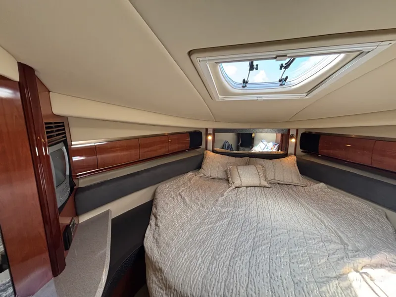 Slide: The Image of The cabin of the 2003 Sea Ray 500 Sundancer features a large bed with skylights. - 23