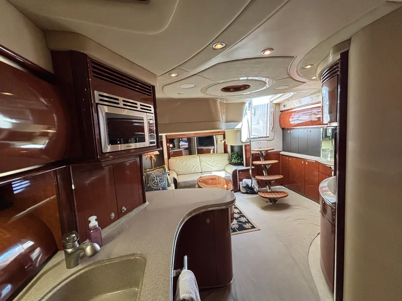 Slide: The Image of Interior of a 2003 Sea Ray 500 Sundancer with elegant kitchen and cozy living area. - 18