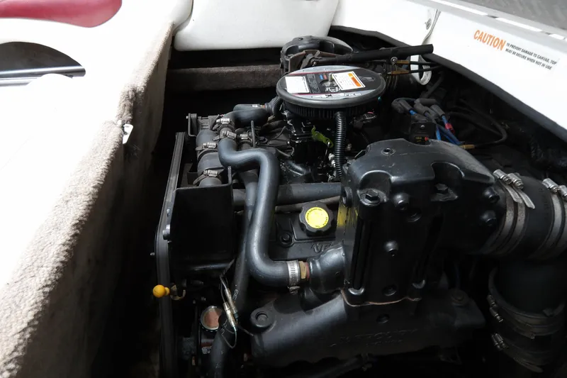 Slide: The Image of Engine compartment of a 2012 Stingray 195 LS/LX boat, showcasing detailed components. - 19