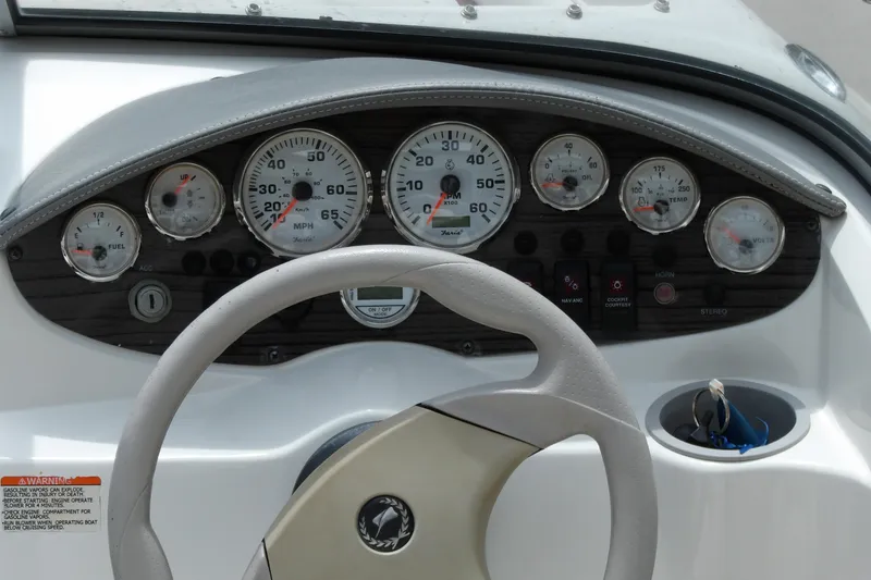 Slide: The Image of Dashboard of a 2012 Stingray 195 LS/LX boat with gauges and steering wheel. - 12