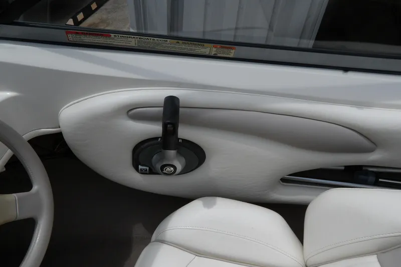 Slide: The Image of Interior of a 2012 Stingray 195 LS/LX boat showing steering wheel and throttle control. - 17