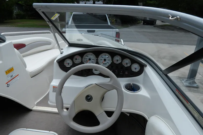Slide: The Image of 2012 Stingray 195 LS/LX boat dashboard with steering wheel and gauges. - 8