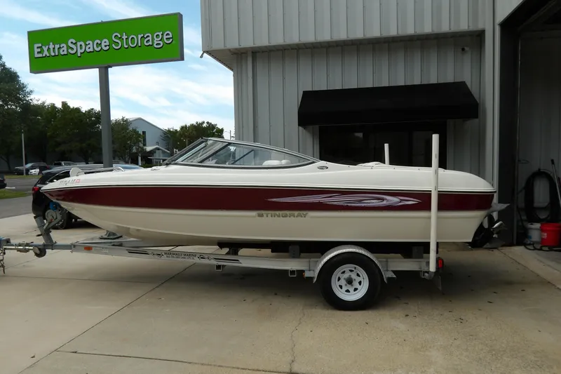 The Image of 2012 Stingray 195 LS/LX boat on trailer outside Extra Space Storage facility. - 1