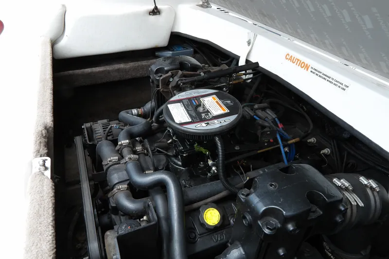 Slide: The Image of Engine compartment of a 2012 Stingray 195 LS/LX boat, showcasing mechanical components. - 20