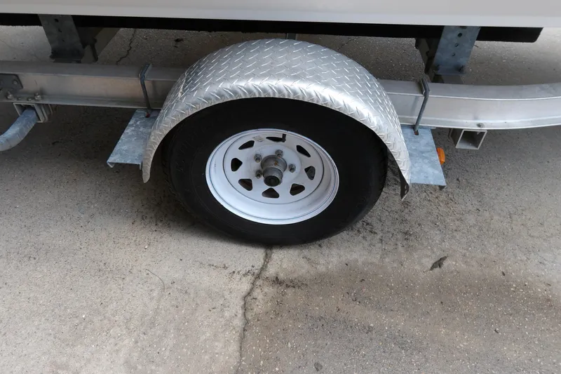 Slide: The Image of Trailer wheel with metal fender on a 2012 Stingray 195 LS/LX boat trailer. - 6