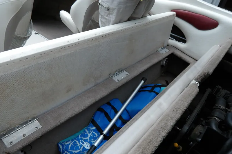 Slide: The Image of 2012 Stingray 195 LS/LX boat interior storage with life jackets and equipment. - 21