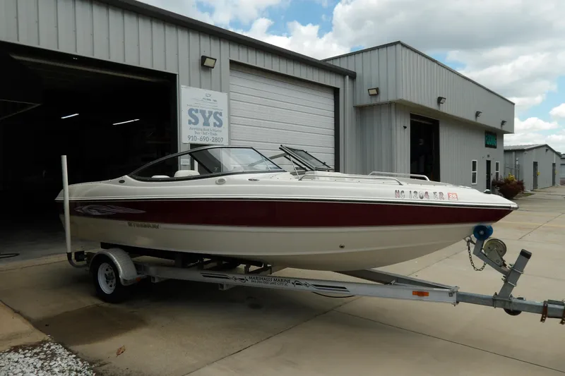 Slide: The Image of 2012 Stingray 195 LS/LX boat on trailer outside a marine service facility. - 4