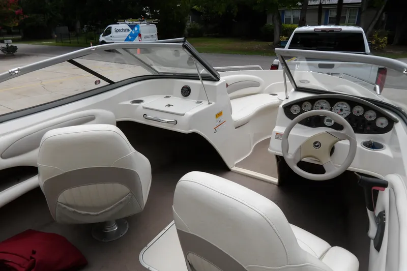 Slide: The Image of 2012 Stingray 195 LS/LX boat interior with white seating and dashboard controls. - 7