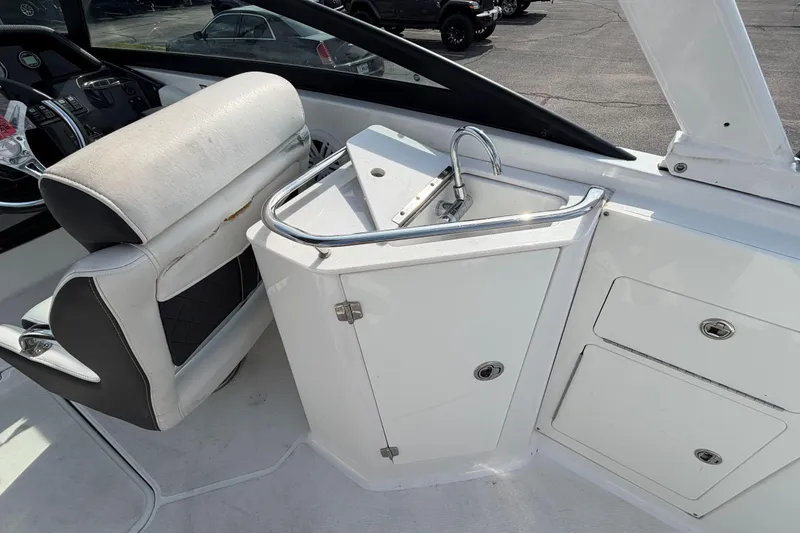 Slide: The Image of Interior of a 2022 Monterey M4 boat featuring a compact sink and storage area. - 26