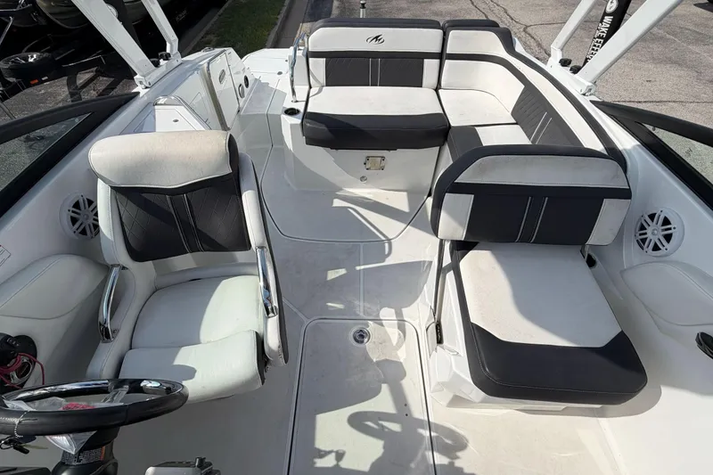 Slide: The Image of 2022 Monterey M4 boat interior with white and black seating, steering wheel, and speakers. - 36