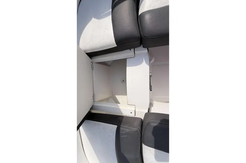Slide: The Image of 2022 Monterey M4 boat interior storage compartment with black and white seating. - 7