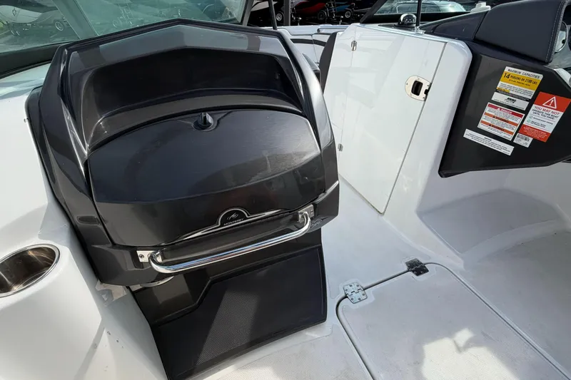 Slide: The Image of 2022 Monterey M4 boat interior with sleek black dashboard and safety warnings. - 8