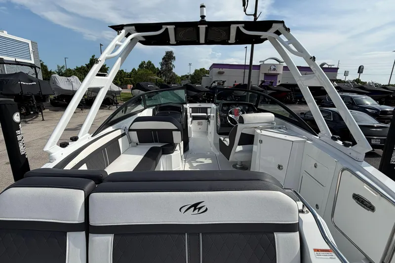 Slide: The Image of 2022 Monterey M4 boat interior with seating and helm, displayed outdoors. - 23