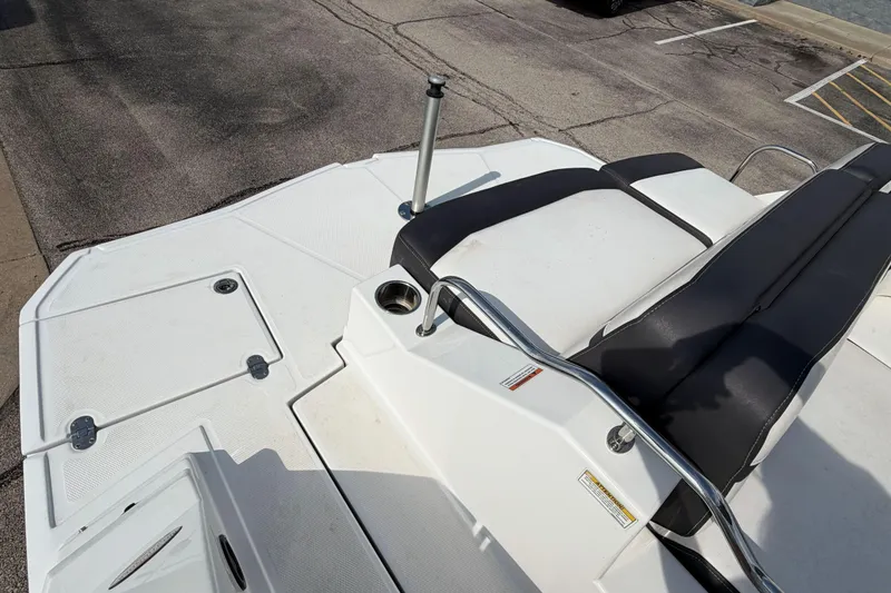 Slide: The Image of 2022 Monterey M4 boat deck with seating and cup holder, parked on pavement. - 20