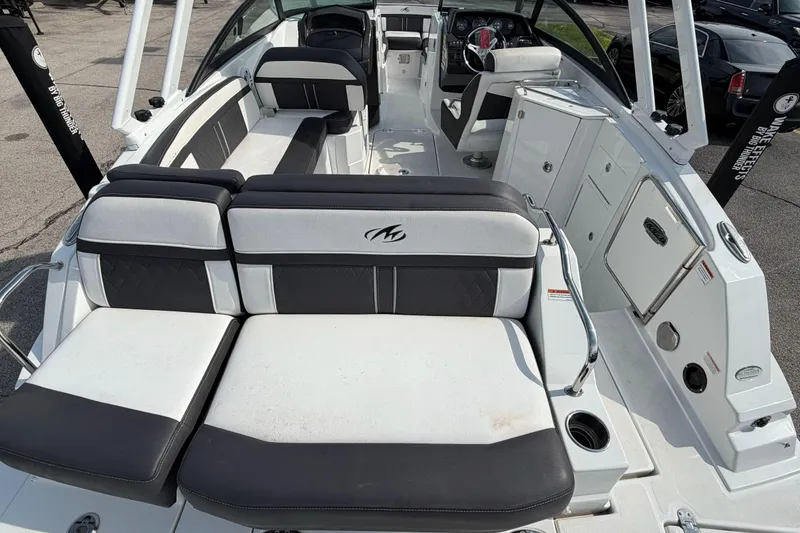 Slide: The Image of 2022 Monterey M4 boat interior with black and white seating and modern dashboard. - 22