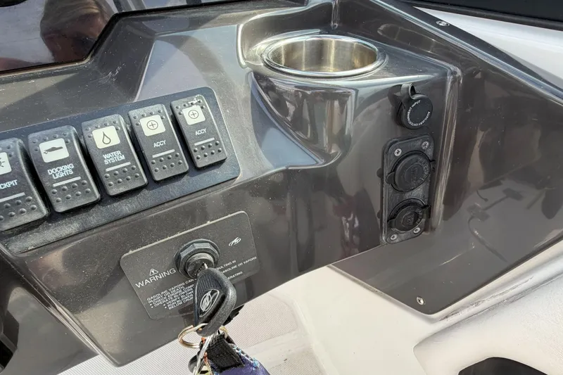 Slide: The Image of Control panel of a 2022 Monterey M4 boat with switches and cup holder. - 10