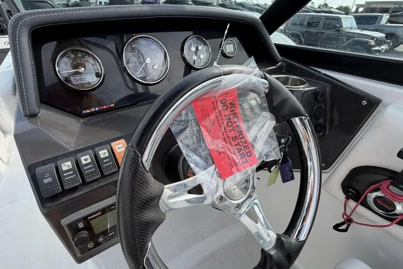 Slide: The Image of Steering wheel and dashboard of 2022 Monterey M4 boat with winterized warning tag. - 13