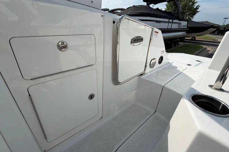 Slide: The Image of 2022 Monterey M4 boat deck with storage compartments and cup holder. - 27