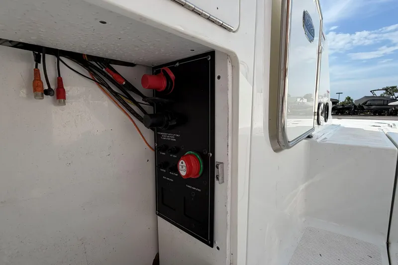Slide: The Image of Electrical panel on a 2022 Monterey M4 boat, featuring various switches and wiring. - 28