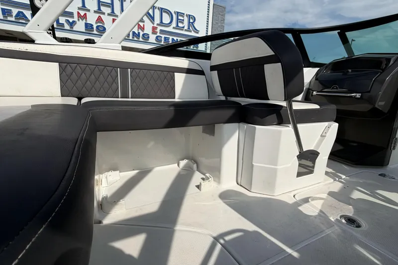 Slide: The Image of Interior of a 2022 Monterey M4 boat featuring sleek black and white seating. - 30