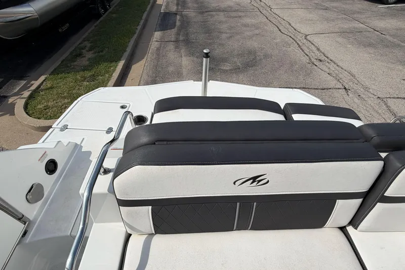 Slide: The Image of 2022 Monterey M4 boat interior with black and white seating, parked on pavement. - 21