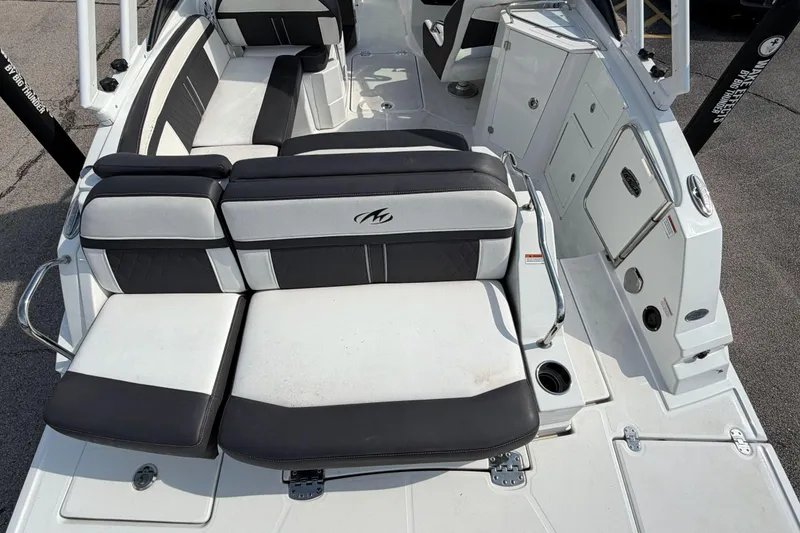 Slide: The Image of 2022 Monterey M4 boat interior with black and white seating and storage compartments. - 24