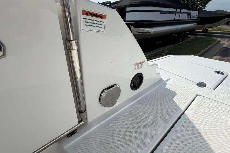 Slide: The Image of 2022 Monterey M4 boat deck with safety warning label and sleek design. - 25