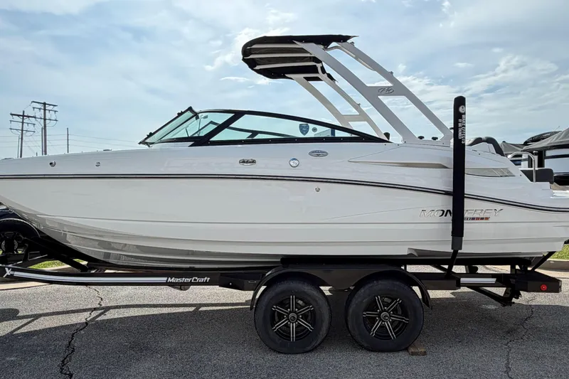Slide: The Image of 2022 Monterey M4 boat on trailer, side view, under a cloudy sky. - 3