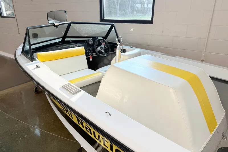 Slide: The Image of 1978 Correct Craft Ski Nautique boat with yellow and white interior, parked indoors. - 2