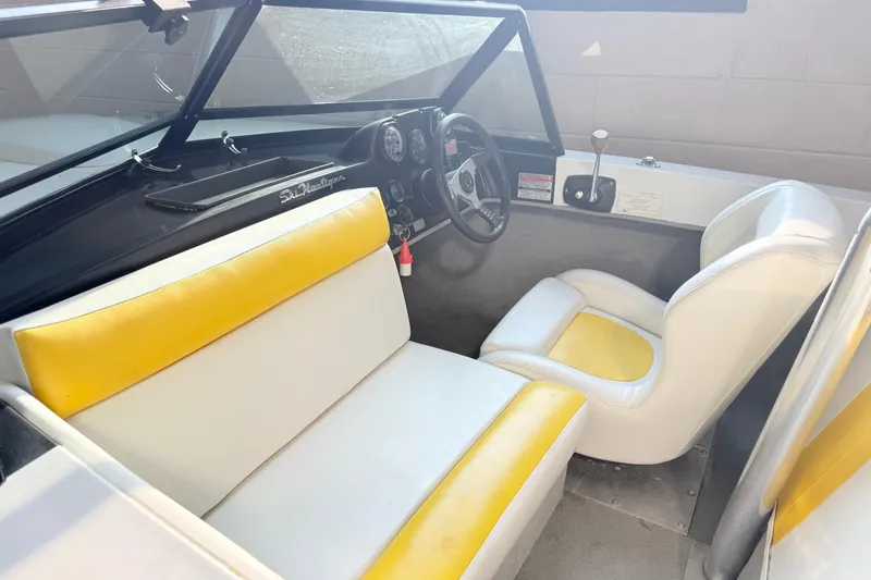 Slide: The Image of 1978 Correct Craft Ski Nautique interior with yellow and white seating, steering wheel, and dashboard. - 10