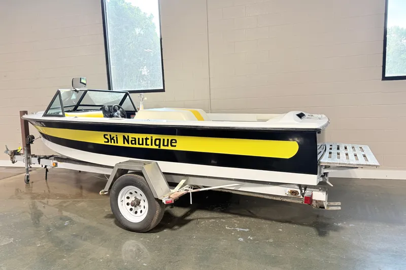 Slide: The Image of 1978 Correct Craft Ski Nautique boat on trailer, indoors, with yellow and black design. - 1