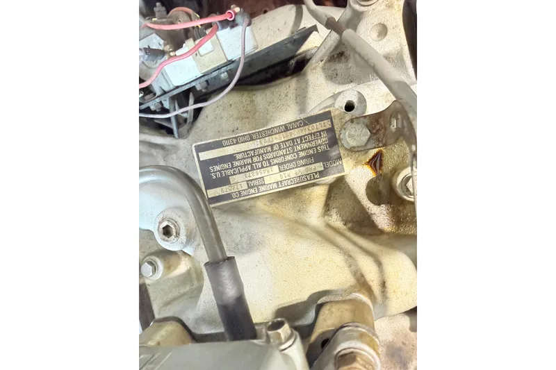 Slide: The Image of 1978 Correct Craft Ski Nautique engine with visible wiring and identification plate. - 7