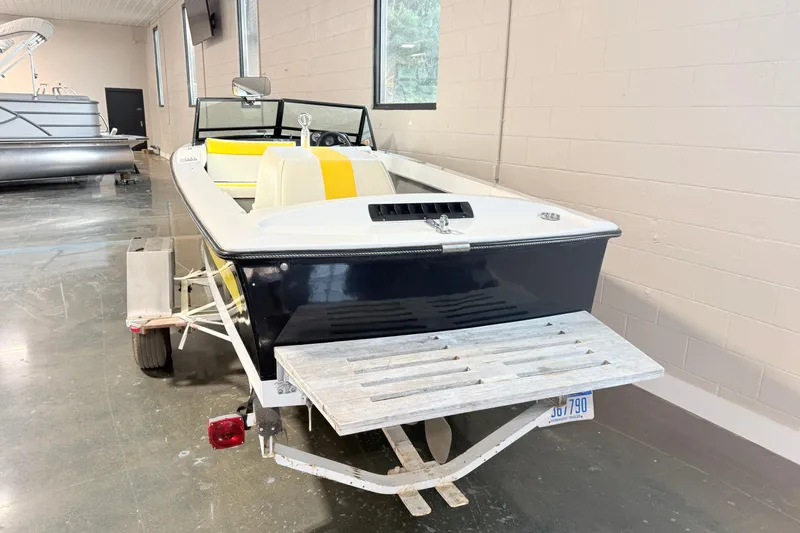 Slide: The Image of 1978 Correct Craft Ski Nautique boat on trailer in indoor showroom. - 3