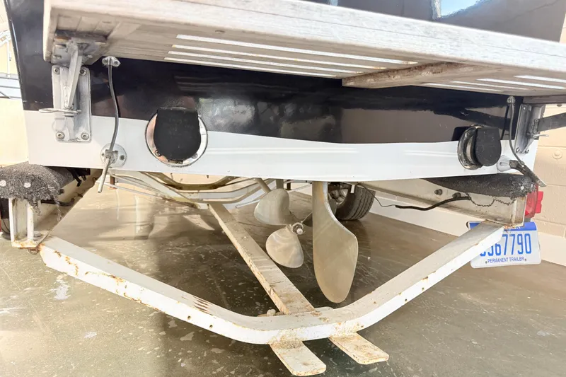 Slide: The Image of 1978 Correct Craft Ski Nautique boat on trailer, showing propeller and rear details. - 8