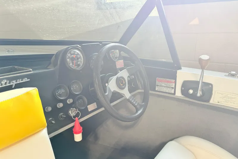 Slide: The Image of 1978 Correct Craft Ski Nautique dashboard with steering wheel and control panel. - 13